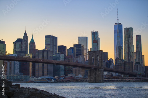 Illuminated Manhattan skyline during the sunset over the river Hudson. New York City, USA.