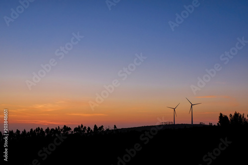 sunset over some wind turbine generator