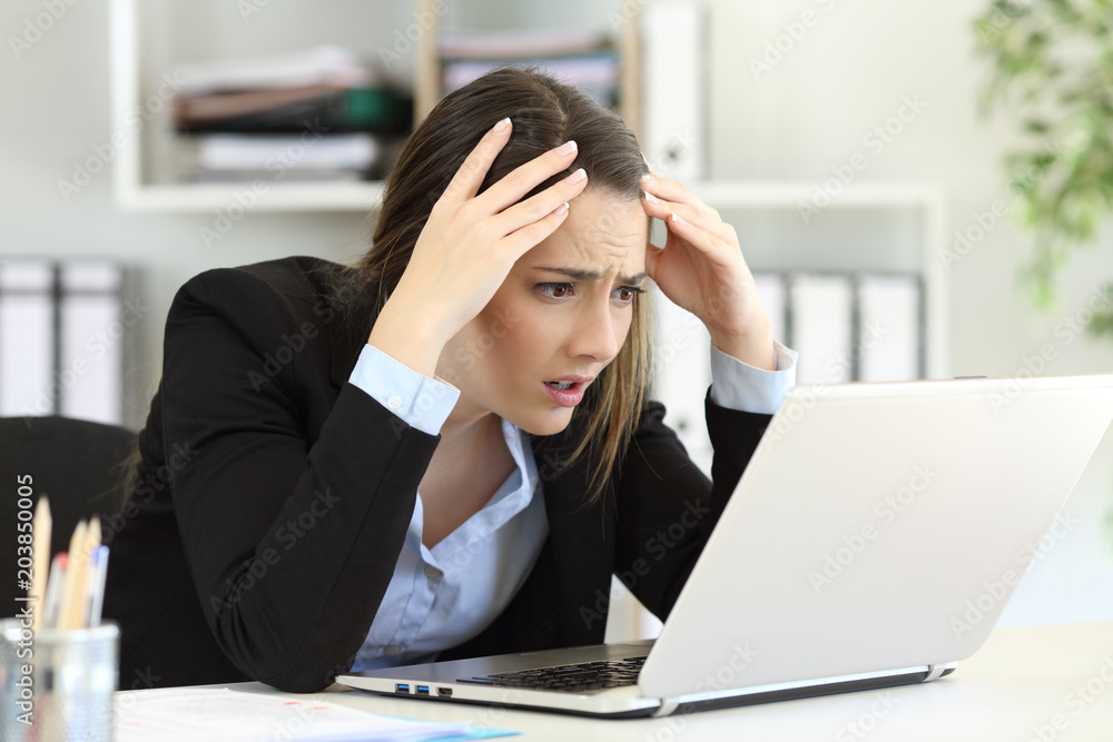 Worried executive receiving bad news on line at office Worried executive receiving bad news on line at office