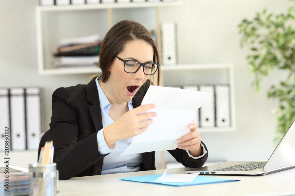 Bored office worker yawning reading documents Bored office worker yawning reading documents