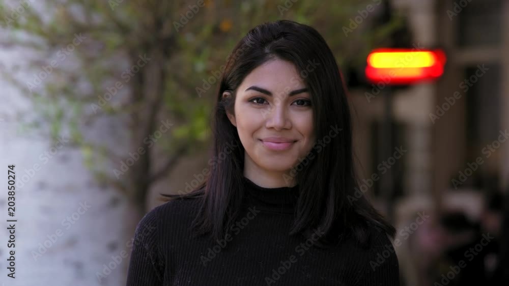 beautiful Filipino woman looking at camera and smiling - oudoor beautiful Filipino woman looking at camera and smiling - oudoor
