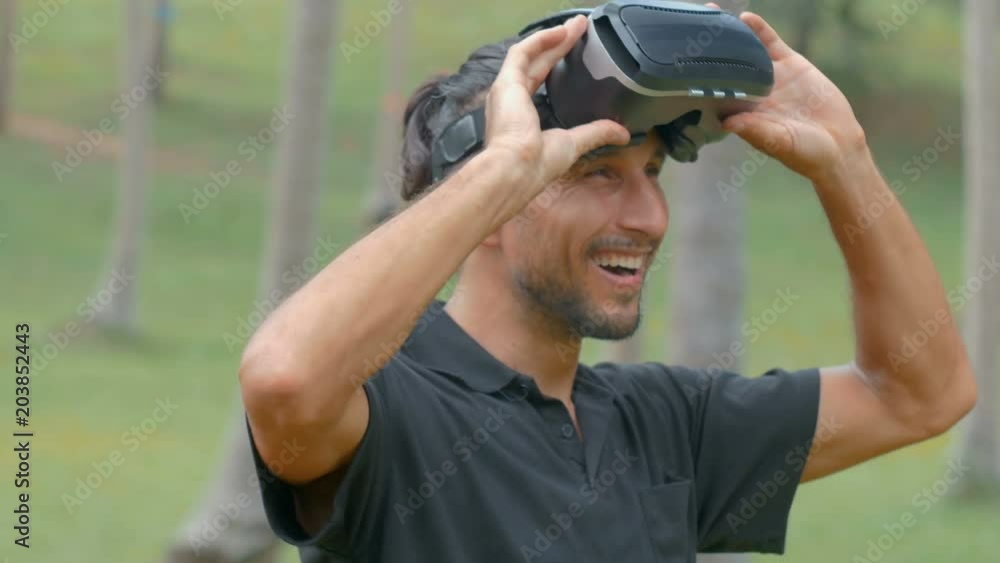 Man using virtual reality headset in the jungle Man using virtual reality headset in the jungle