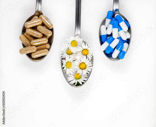 Medicines and food supplements on spoons