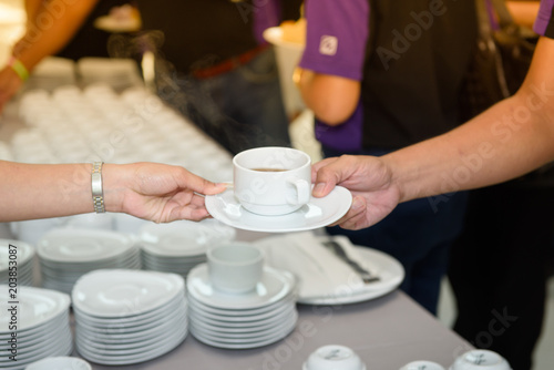 The staff is serving hot coffee to customers.