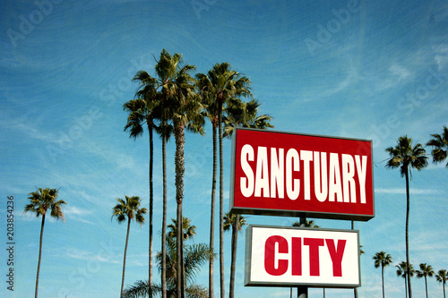 sanctuary city sign with palm trees