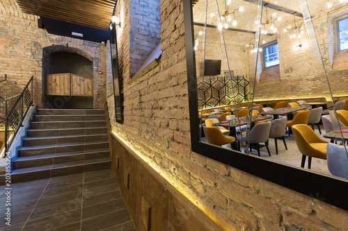 Interior of a modern hotel restaurant with brick wall