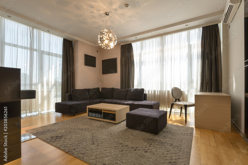 Fototapeta premium Interior of a modern open plan hotel apartment, living room