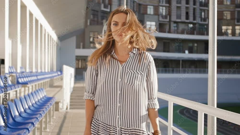 Slow motion video of beautiful young woman walking on street and sending air kiss in camera Slow motion video of beautiful young woman walking on street and sending air kiss in camera
