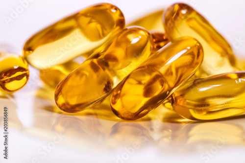 Close up the vitamin D and Omega 3 fish oil capsules supplement for good brain , heart and health eating benefit