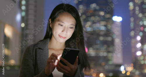 Young Business woman use of cellphone at night