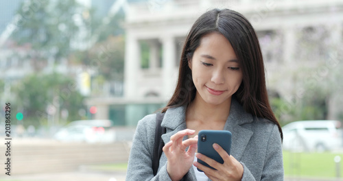 Photography Business woman use of smart phone in Hong Kong