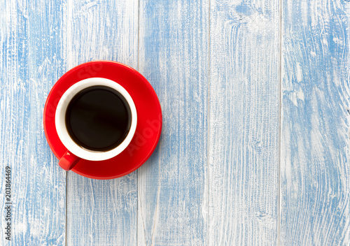 Red cup coffee on blue wooden table, Top view with copy space