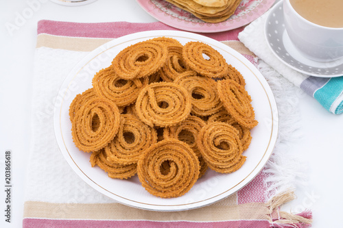 Indian Traditional Snack Chakli, a spiral shaped crisp deep fried snack, It is known as  Chakali, Murukku, Muruku, Murkoo, Chakri in Gujarat, Chakli in Maharashtra and Northern India photo