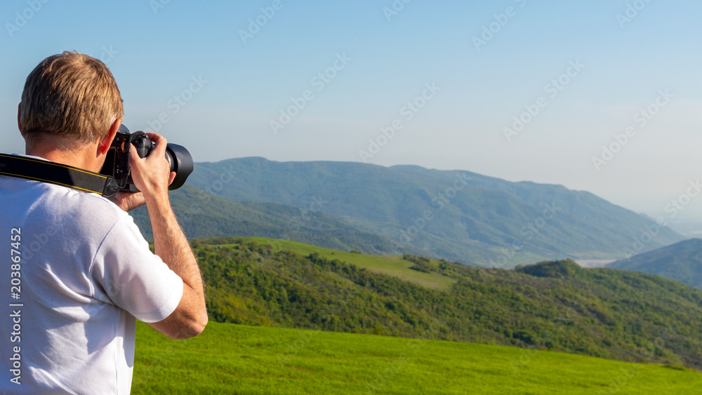 Nature photographer in mountains