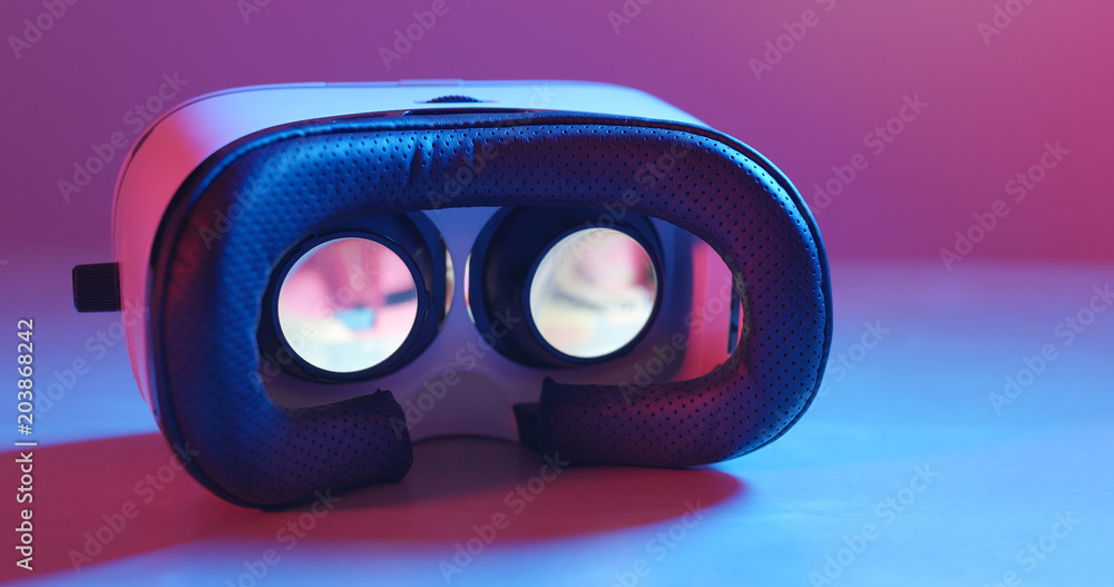 Holding virtual reality device with pink and blue light