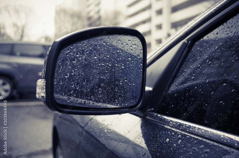 Raindrops on side rearview mirror in rainy day. Raindrops on side rearview mirror in rainy day.