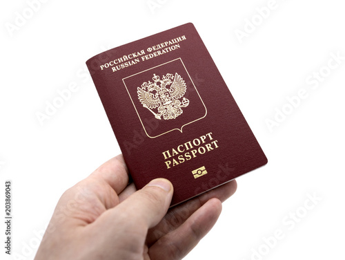 International Russian passport in a male hand on an isolated background
