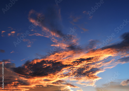 Dark with pink and gold color cloud on beautiful blue sky at sunset , Fluffy clouds formations at tropical zone 