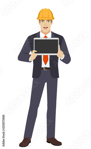 Businesswoman in construction helmet showing blank digital tablet PC