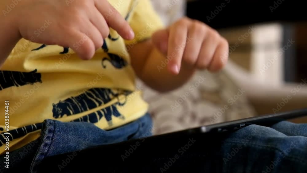 Little boy Playing with Tablet, close up Little boy Playing with Tablet, close up