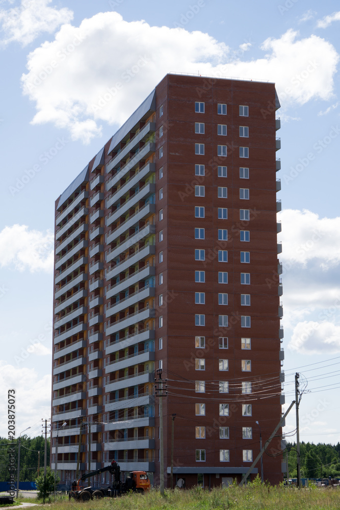 Fototapeta premium Multi-storey residential apartment buildings over blue sky .