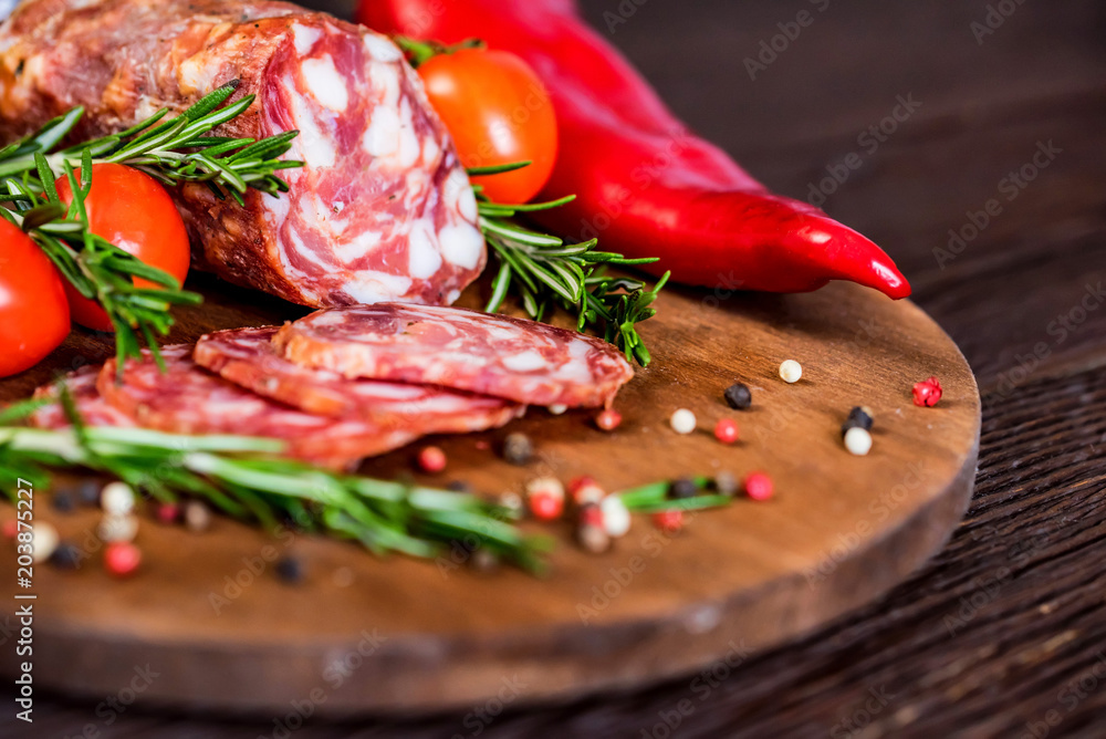 Tasty salami with tomatoes and peppercorn close Tasty salami with tomatoes and peppercorn close