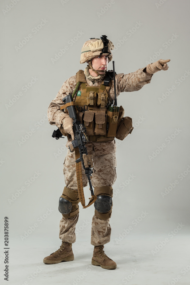 Soldier in camouflage holding rifle Soldier in camouflage holding rifle