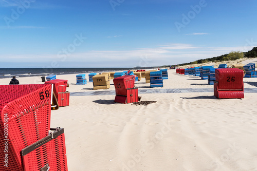 Fototapeta Naklejka Na Ścianę i Meble -  Red beach chairs on a sunny day at the Baltic Sea