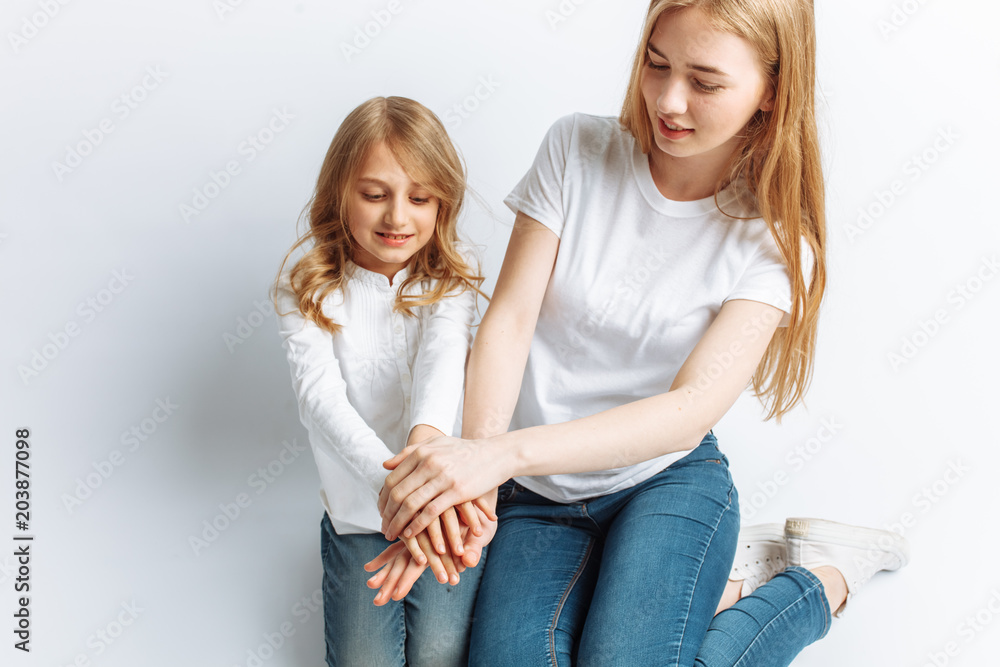 Mom and little daughter looking at each other, happy family, isolated background, cute and beautiful Mom and little daughter looking at each other, happy family, isolated background, cute and beautiful