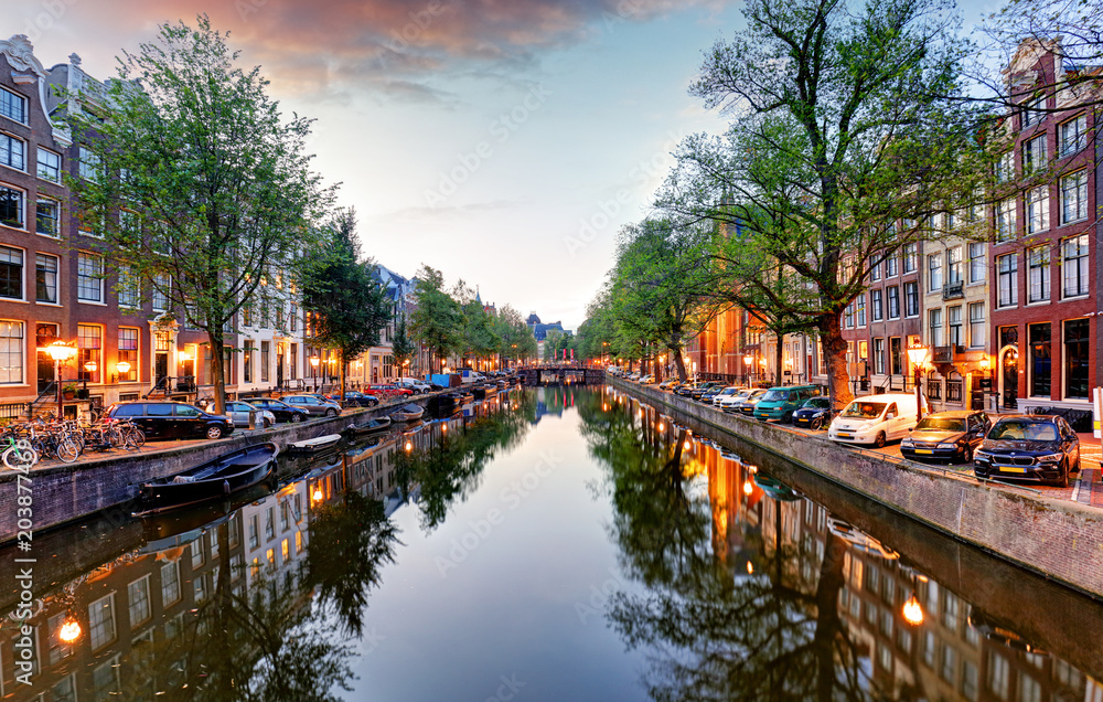Sunset city view of Amsterdam, the Netherlands with Amstel river Sunset city view of Amsterdam, the Netherlands with Amstel river