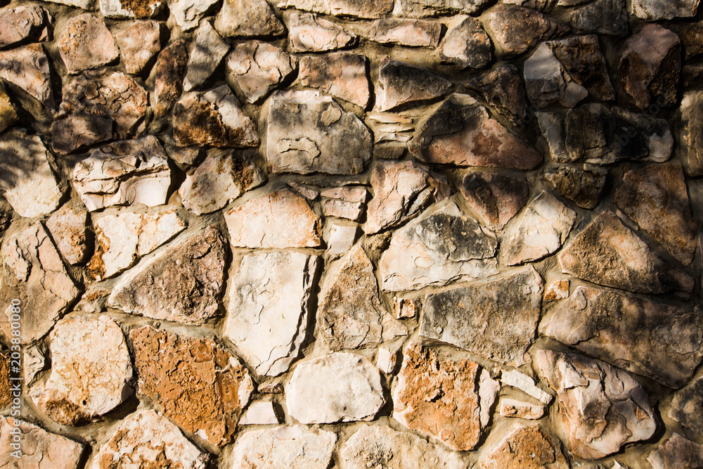 Fototapeta premium Close up of natural stone wall. Stone wall texture 