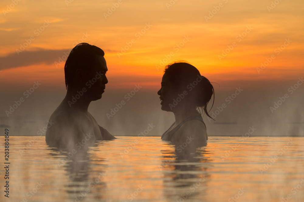 Faith and trust with strong warm feeling and emotional connection.  True love and romance with silhouette and sunset in background.