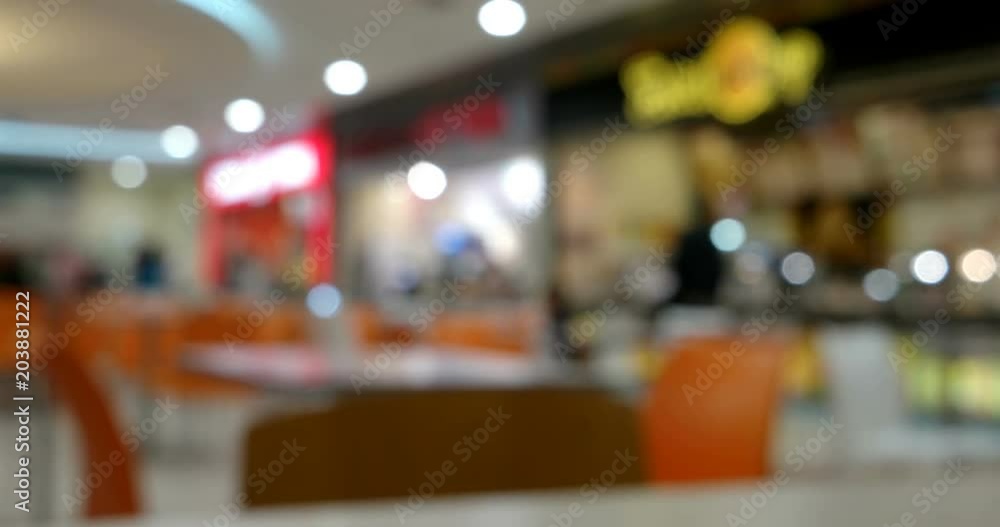 Food court defocused timelapse. Interior Of Eating Zone Of Shopping Mall Food court defocused timelapse. Interior Of Eating Zone Of Shopping Mall