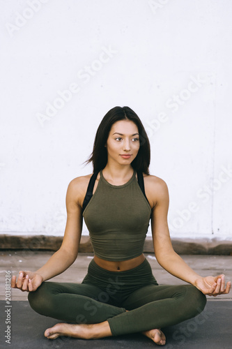 Attractive model in yoga pose on white background in sexual clothes