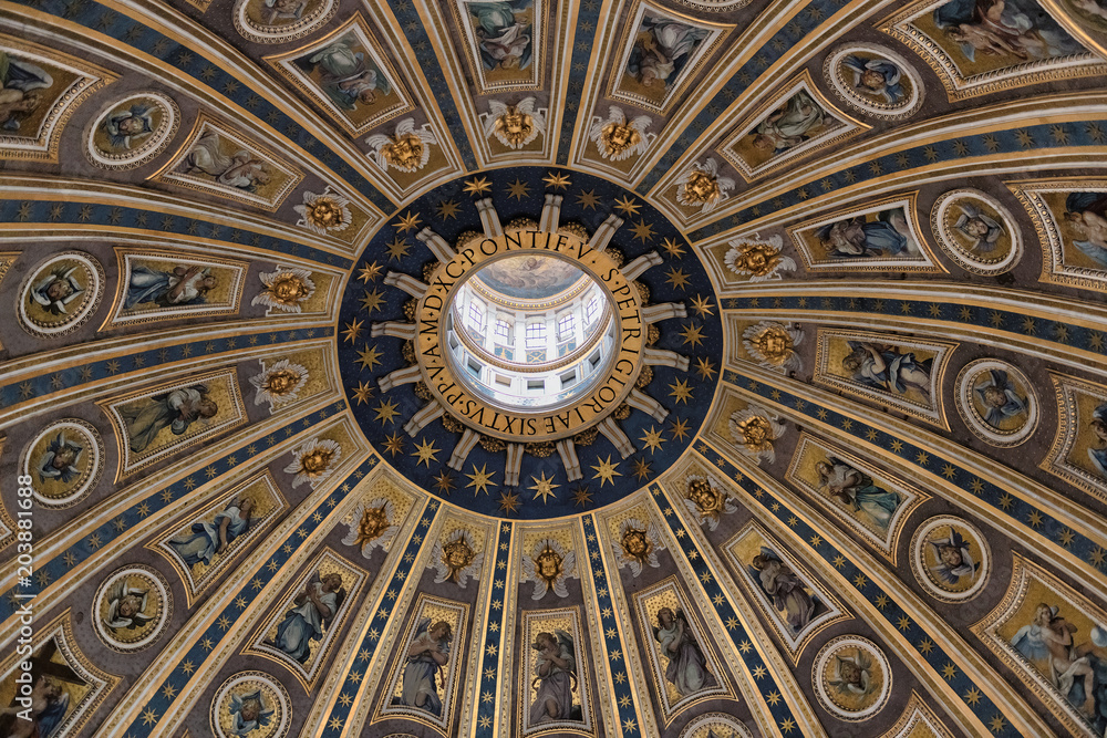 Close-up details of the dome of St. Peter's Basilica, with blue and gold motifs, saints and angels in Vatican, Rome, Italy.