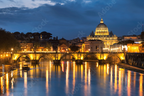 Rome skyline. Night view at Tiber and St. Peter's cathedral in Rome, Italy.