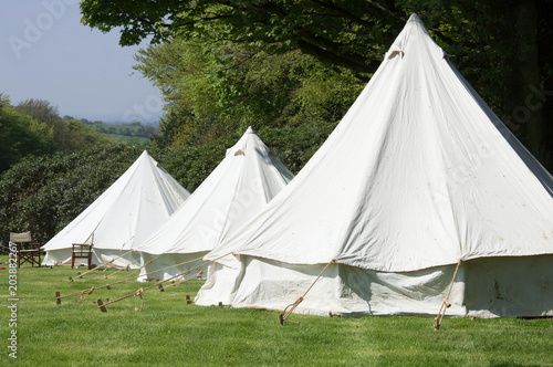 Old style double circular canvas tents in field © Michael Pop