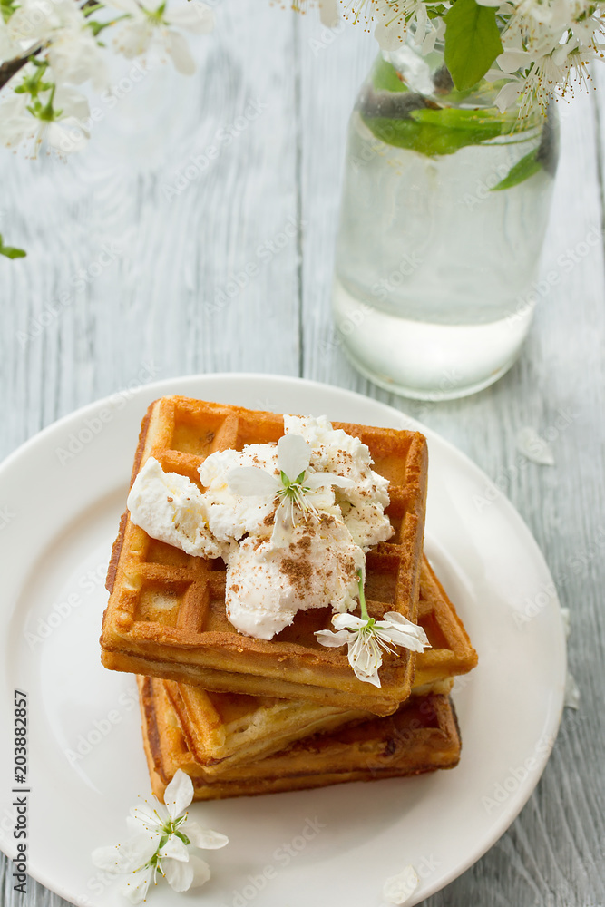 delicious Viennese waffles with ice creamon saucer in spring composition on wooden background delicious Viennese waffles with ice creamon saucer in spring composition on wooden background