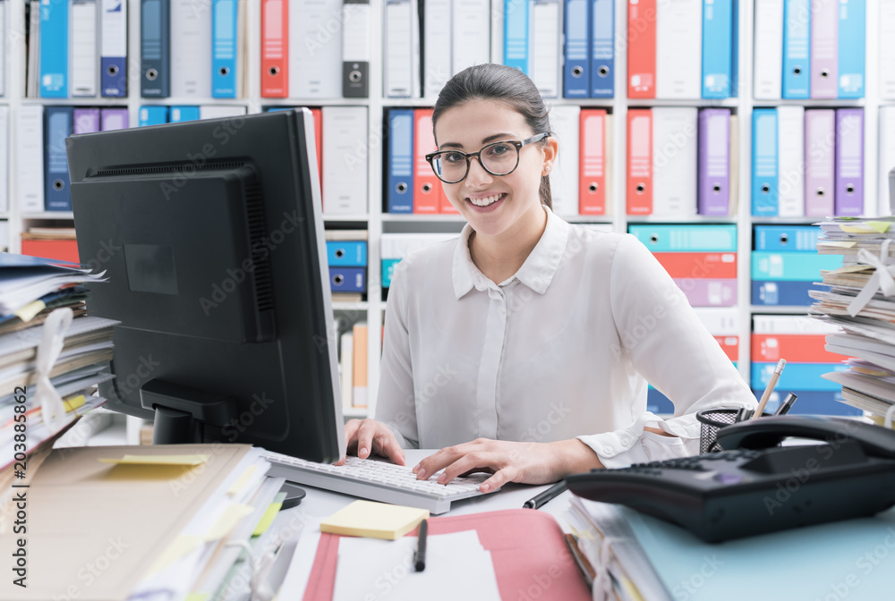 Young secretary working and smiling Young secretary working and smiling