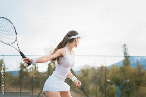 фотографія Woman playing Tennis on court