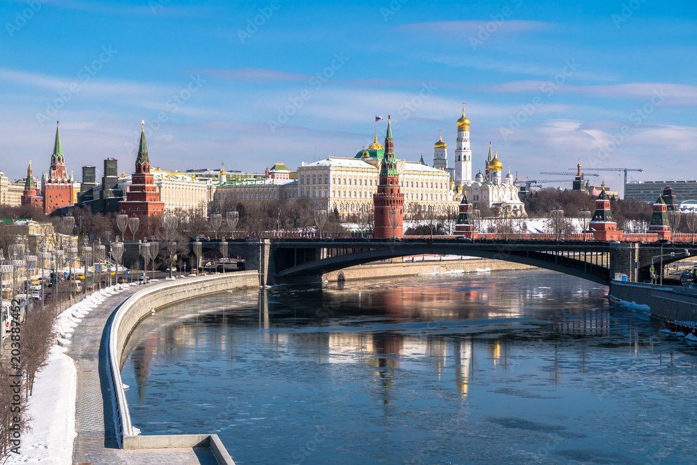 The most recognizable Moscow panoramic view. Bolshoy Kamenny Bridge over the Moscow river. Ancient Kremlin fortress and white stone cathedrals, crowned with golden domes.