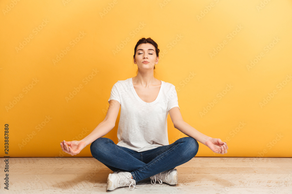 Portrait of a pretty young woman meditating Portrait of a pretty young woman meditating