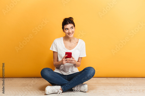 Portrait of a lovely young woman holding mobile phone © Drobot Dean