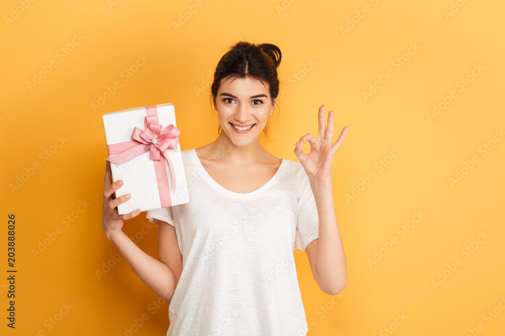 Portrait of an excited young woman holding present Portrait of an excited young woman holding present