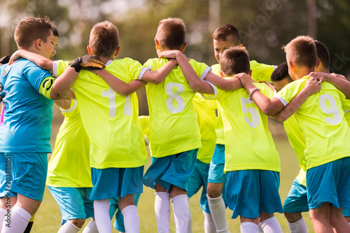 Kids soccer football -  children players celebrating after victory photo