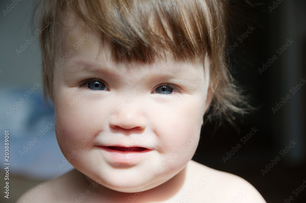 Authentic portrait of smiling baby girl. Little child face closeup in natural light at home. Caucasian kid with blue eyes Authentic portrait of smiling baby girl. Little child face closeup in natural light at home. Caucasian kid with blue eyes