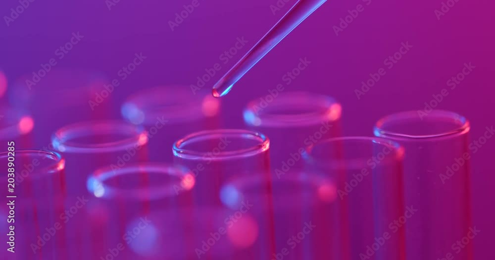 Science laboratory test tubes with purple and blue light