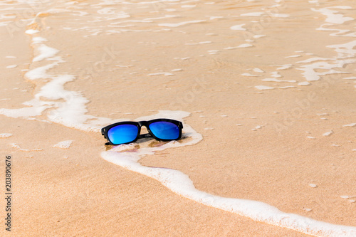 Sun glasses on the sand beach