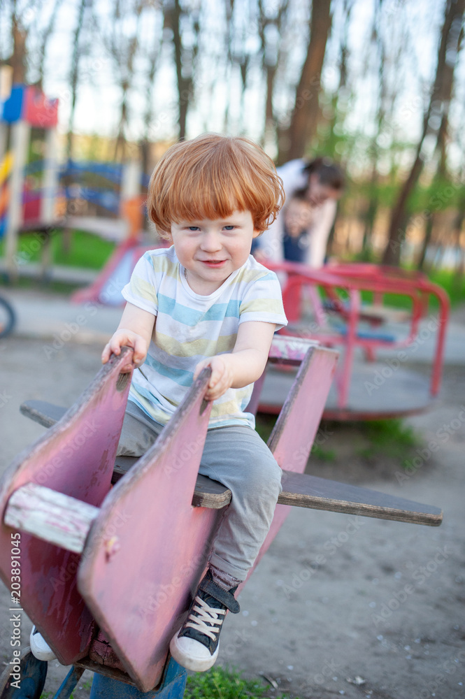 The boy plays in the playground. The boy plays in the playground.