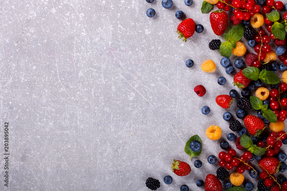 Various fresh summer Berries on the Gray Background.Mix Berries.Food or Healthy diet concept.Super Food.Vegetarian.Top View.Copy space for Text.selective focus. Various fresh summer Berries on the Gray Background.Mix Berries.Food or Healthy diet concept.Super Food.Vegetarian.Top View.Copy space for Text.selective focus.